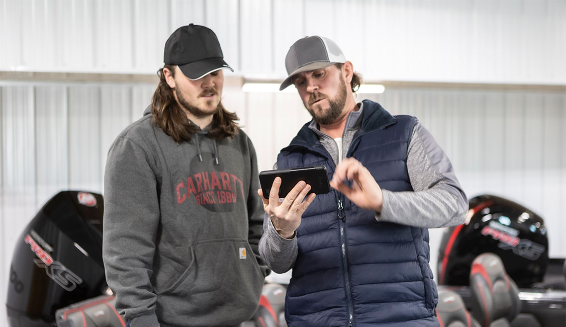 Two men looking at a phone