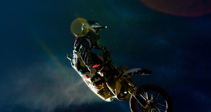 A person on a motor bike in the air