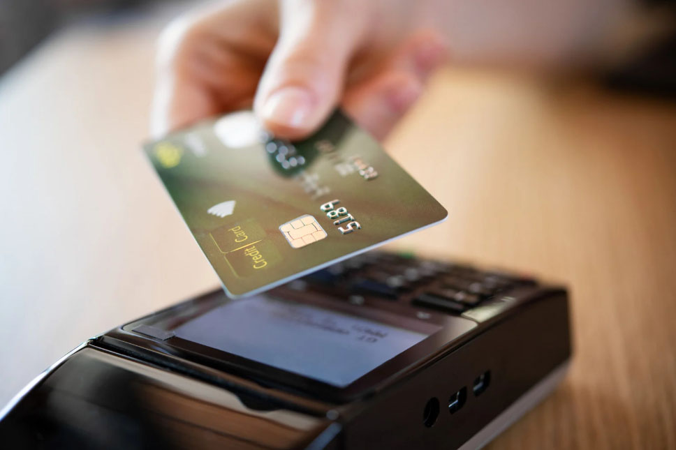 A credit card being used by tapping to pay.
