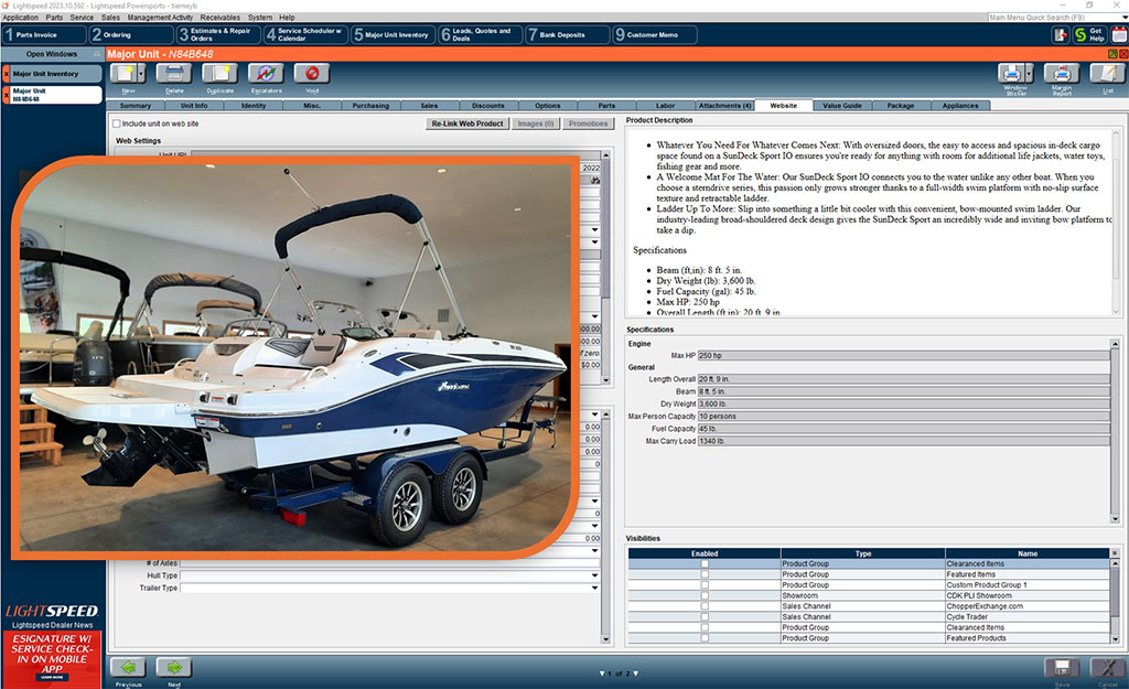 Screenshot of the Lightspeed dealership management software interface displaying detailed inventory information for a Hurricane SunDeck Sport boat. The interface includes tabs for inventory, service, parts, and customer management. A large image of the boat on a trailer is featured.