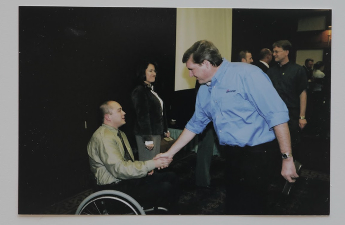 Laurn shaking hands at a banquette.
