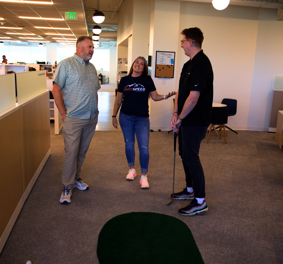 Team Playing Golf in Office
