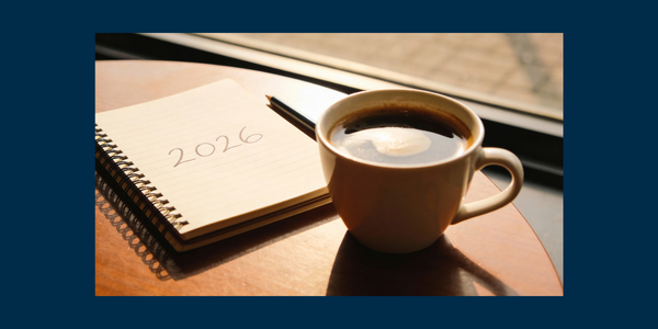 Coffee with a notepad reading "2026"